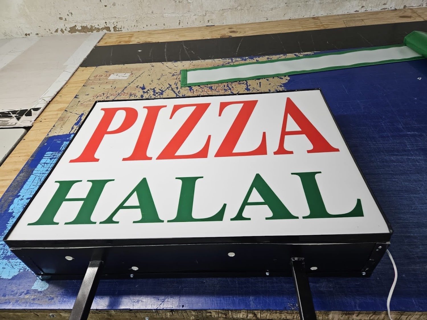 Pizza Halal sign outside Famous Pizza